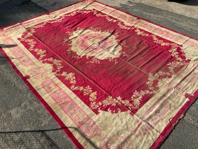 A large Donegal carpet woven in a savonnerie design with oval floral