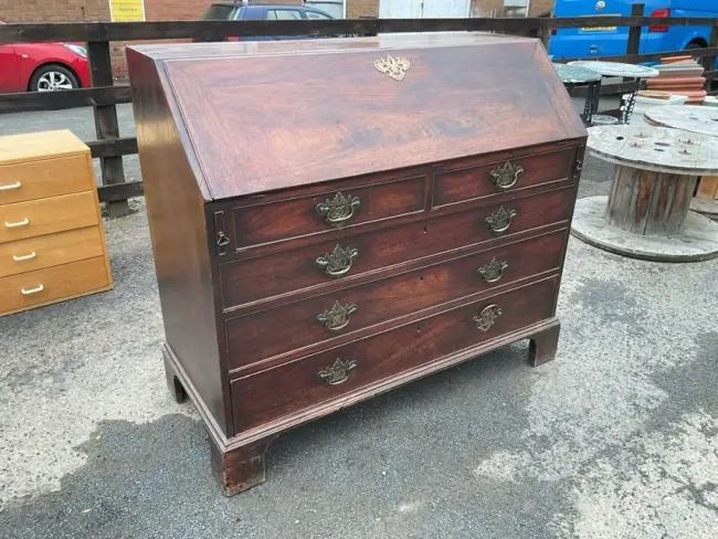A George III mahogany bureau having fitted interior with small drawers