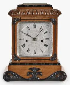 A small, decorative mid 19th century English table or shelf clock by French