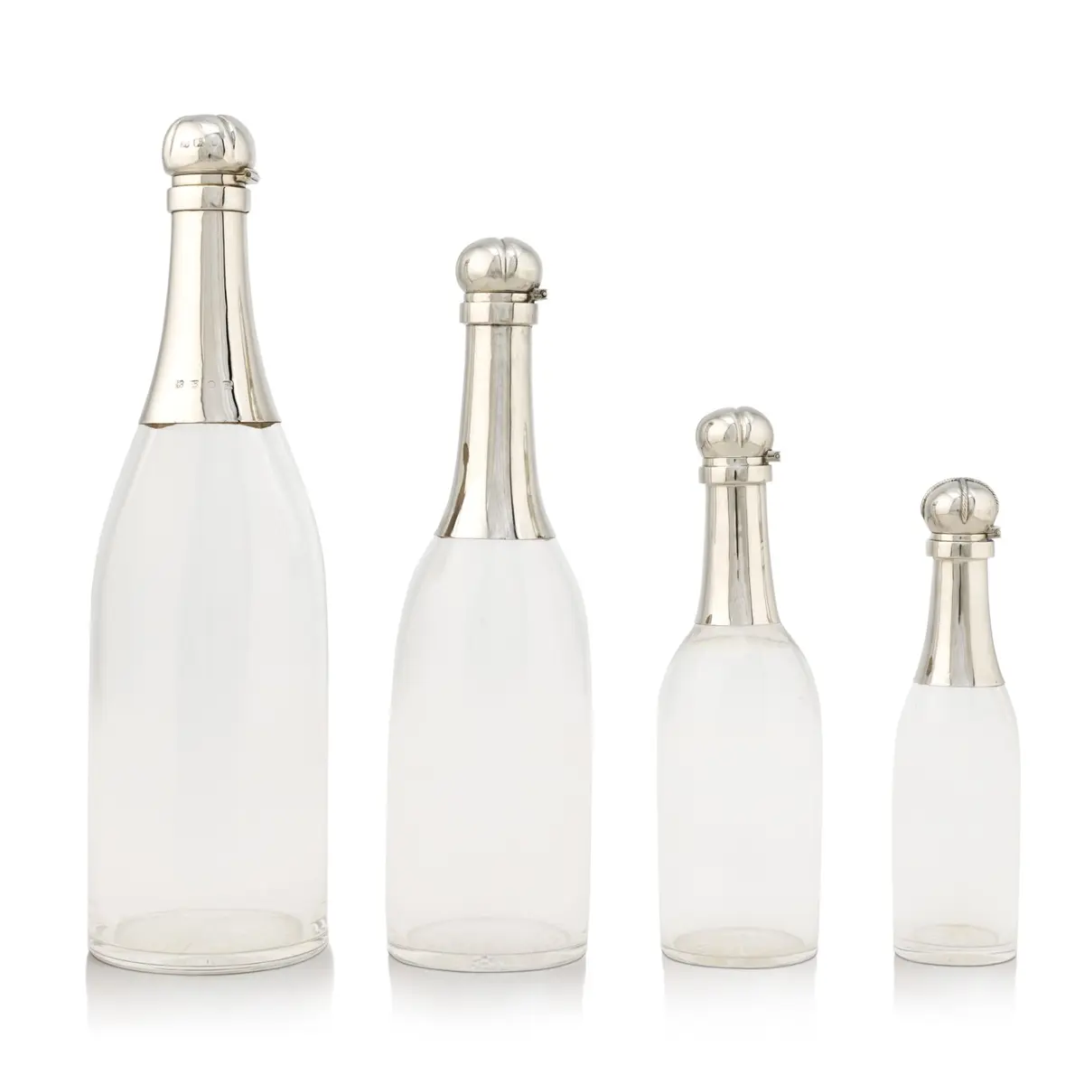 A group of Victorian silver champagne decanters, the largest Hukin