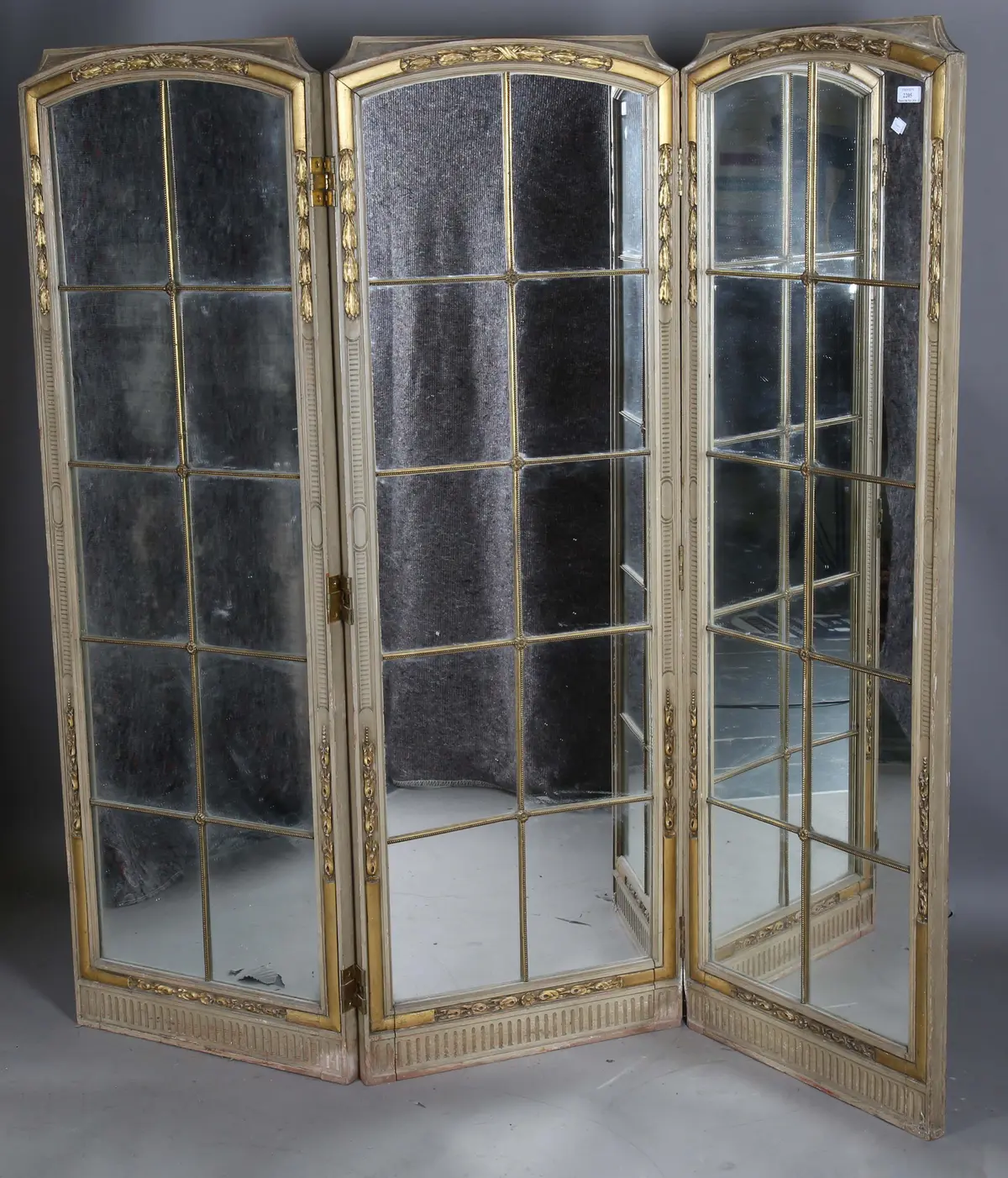 An early 20th century French painted and parcel gilt three-fold dressing