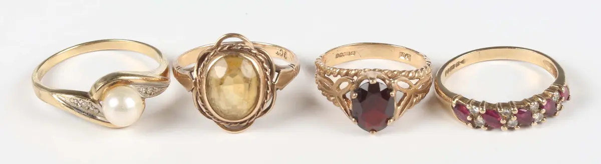 A 9ct gold, ruby and diamond ring, mounted with a row of marquise
