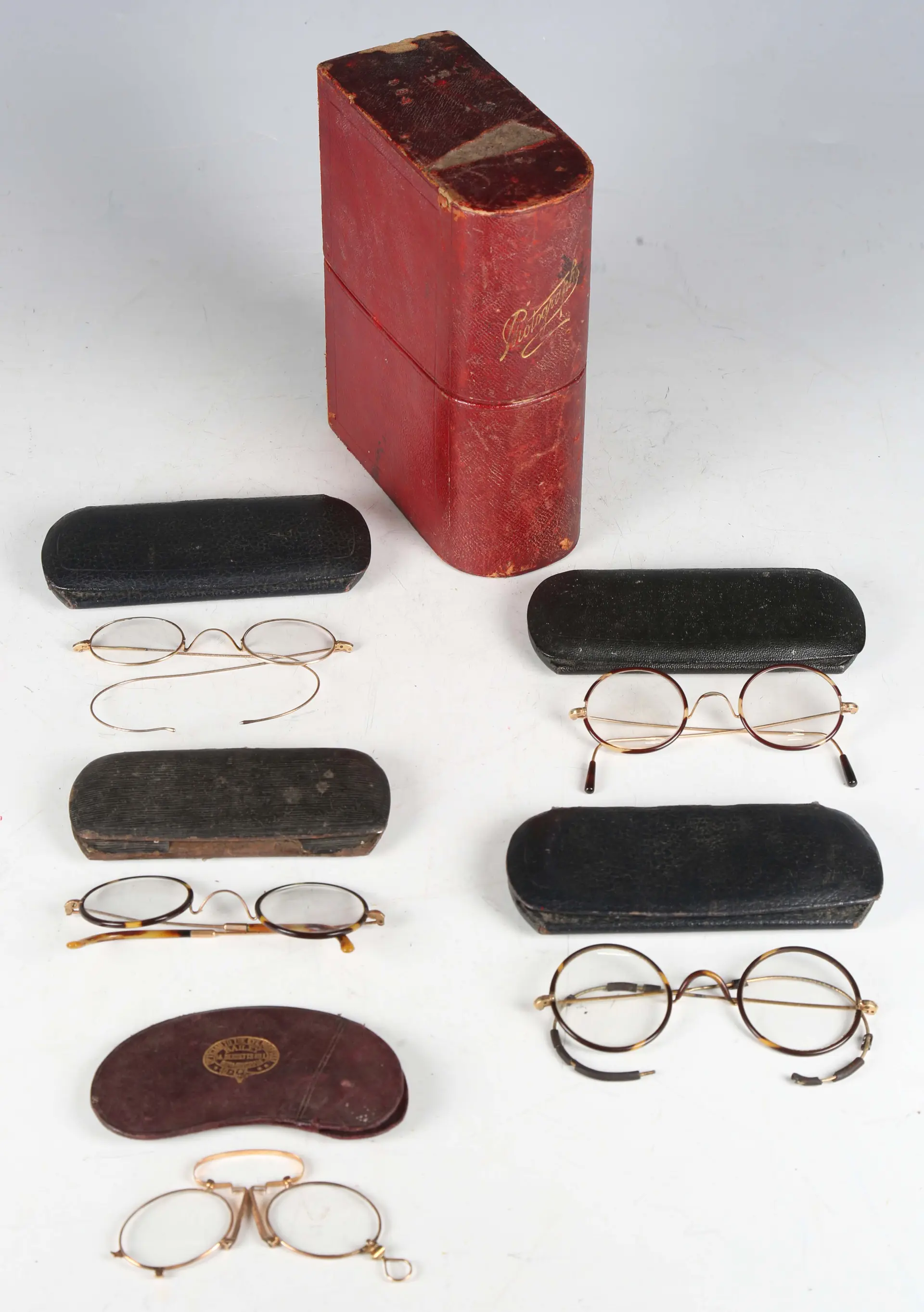 A pair of 12ct gold pince-nez glasses with spring bridge, width 10cm
