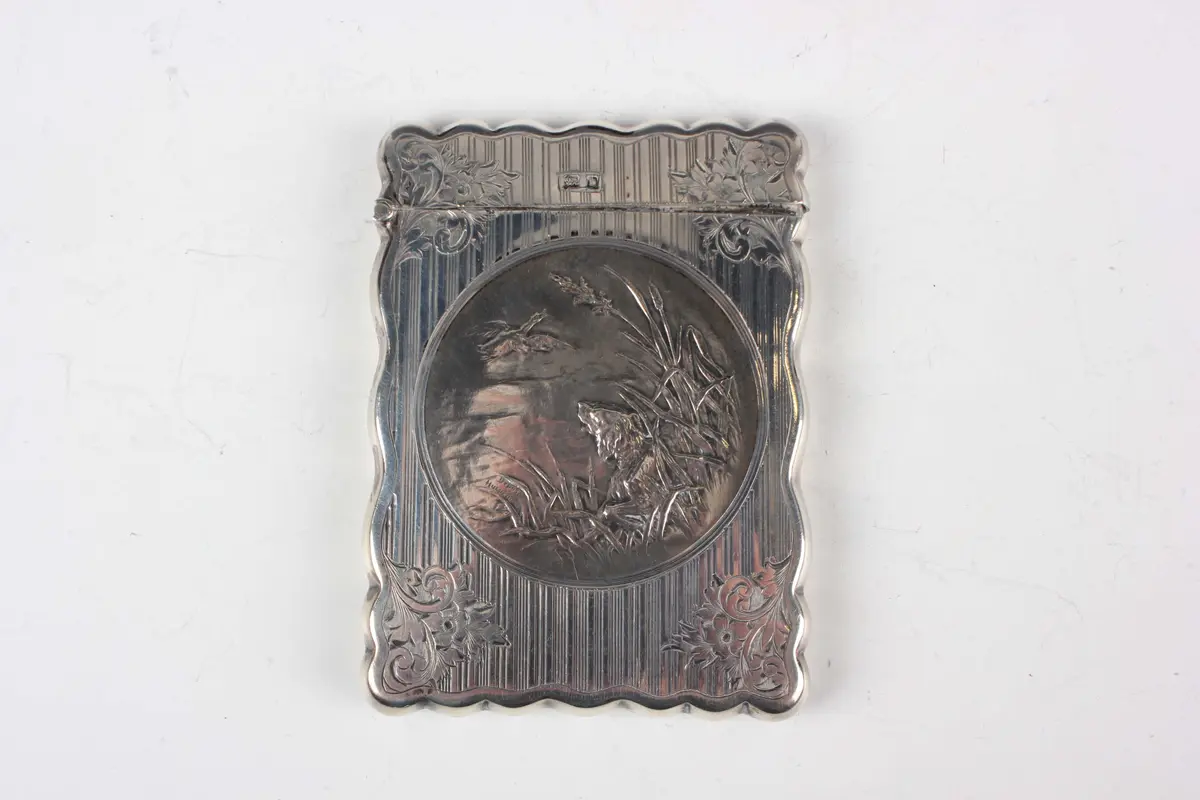 An Edwardian silver rectangular card case with shaped outline, the
