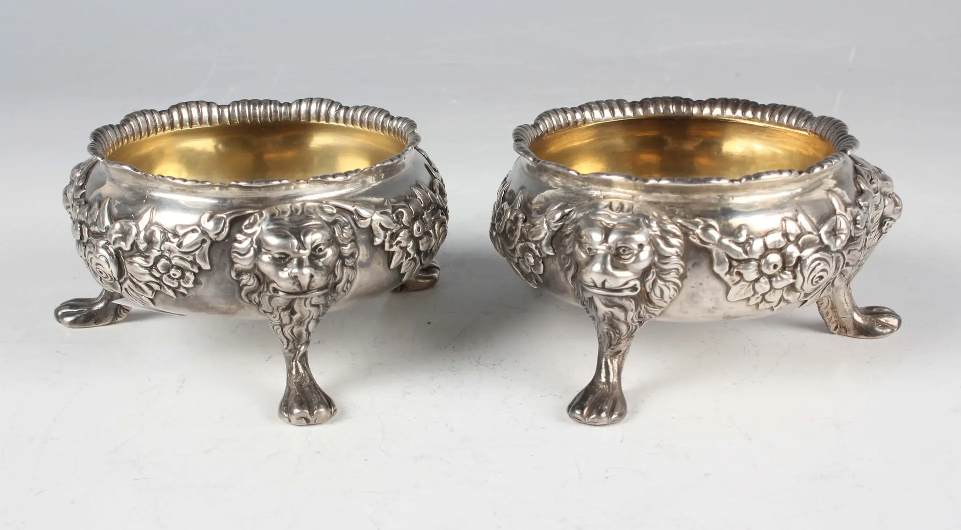 A near pair of mid-18th century silver circular salts, each cast in