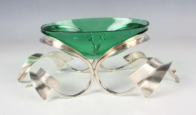 A Modernist silver and green glass bowl, the silver sinuous openwork