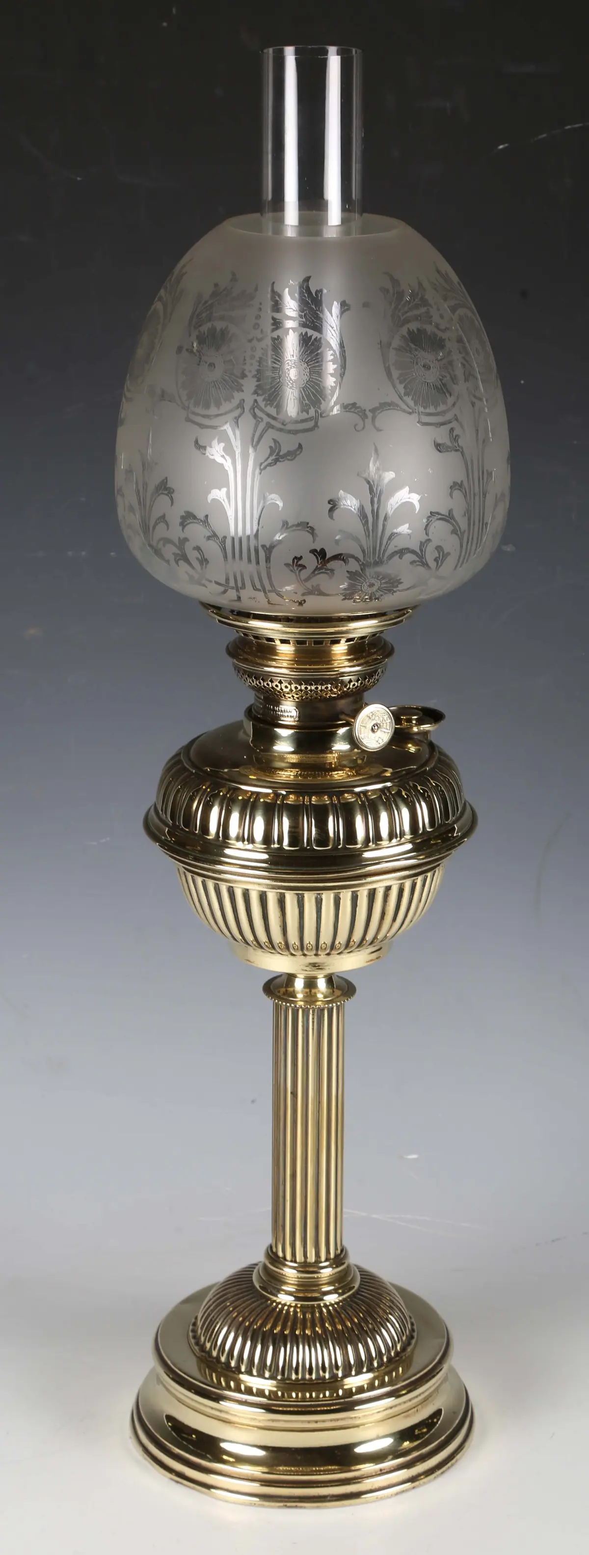 A late Victorian brass table oil lamp with an etched glass shade and