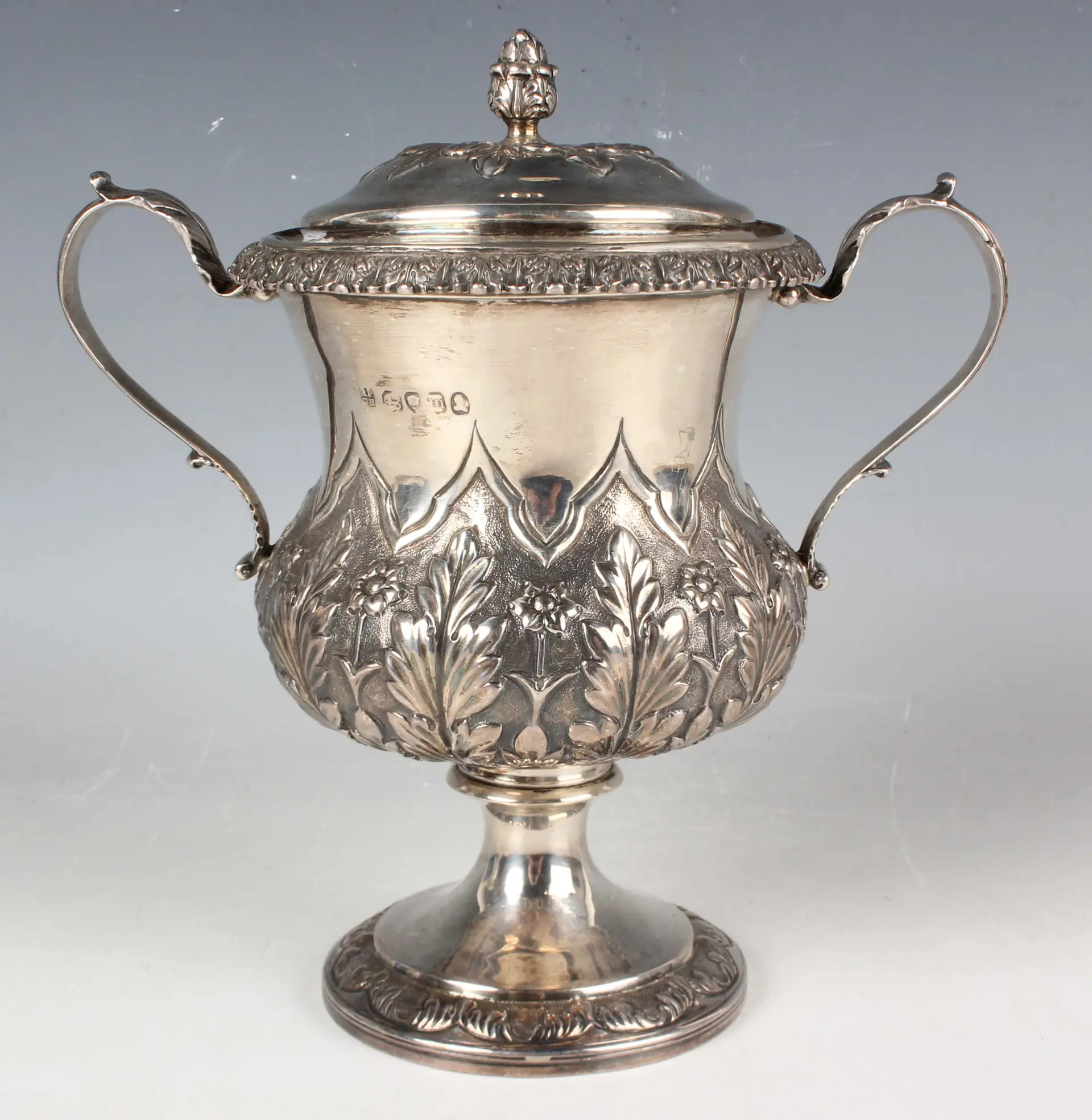 A George IV silver urn shaped trophy cup and cover with flower bud