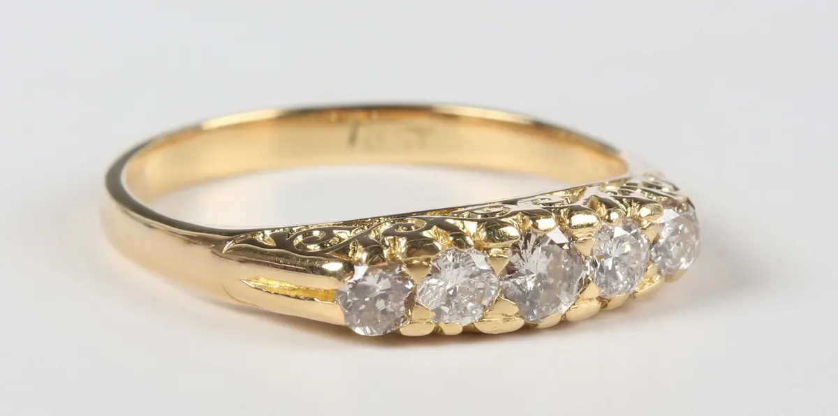 A gold and diamond five stone ring, mounted with a graduated row of