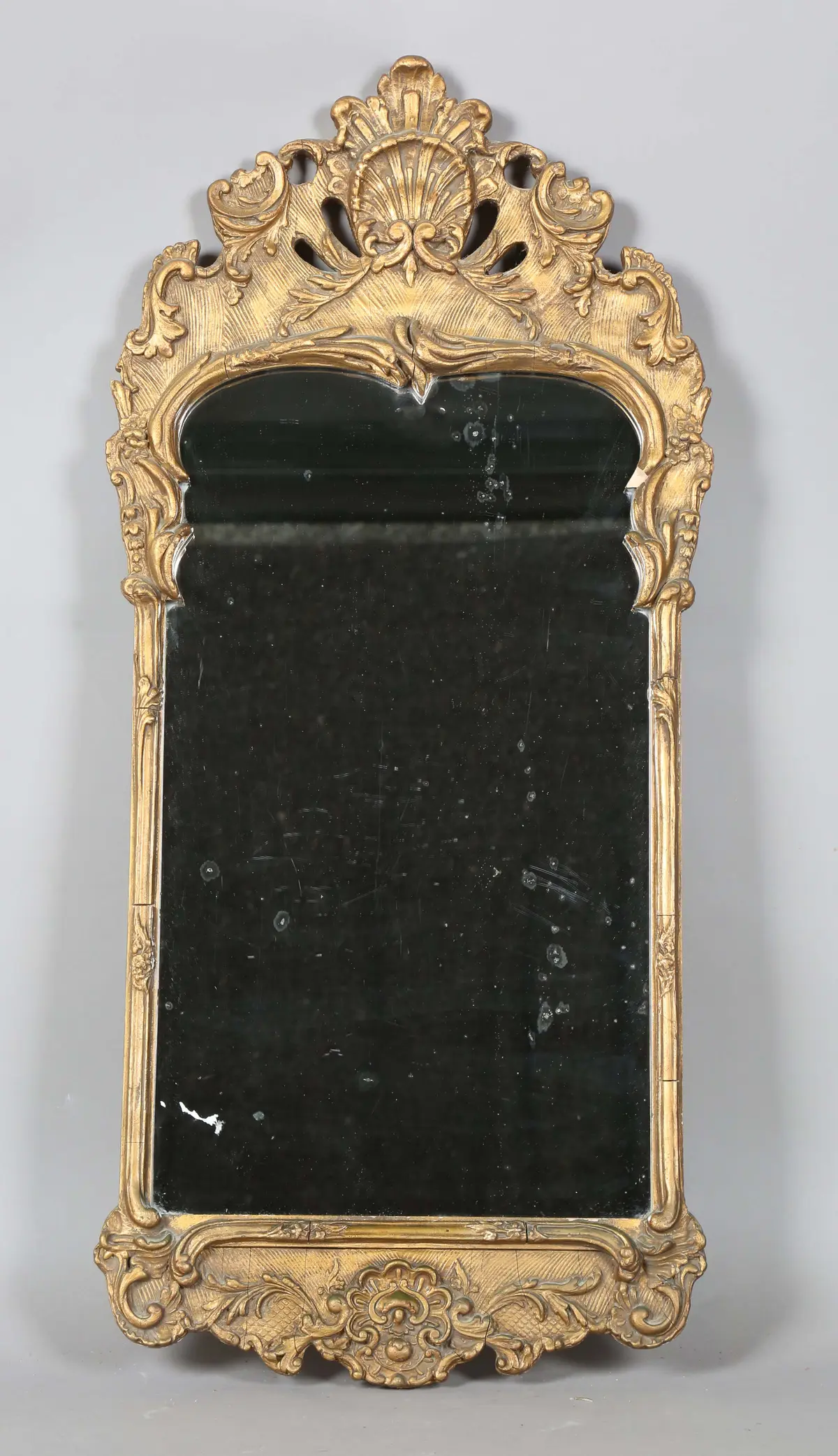 A 20th century Rococo style gilt composition wall mirror, the frame