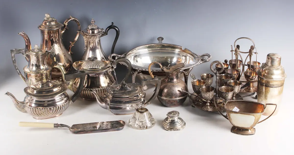 A group of plated items, including an egg cruet and stand, a breakfast