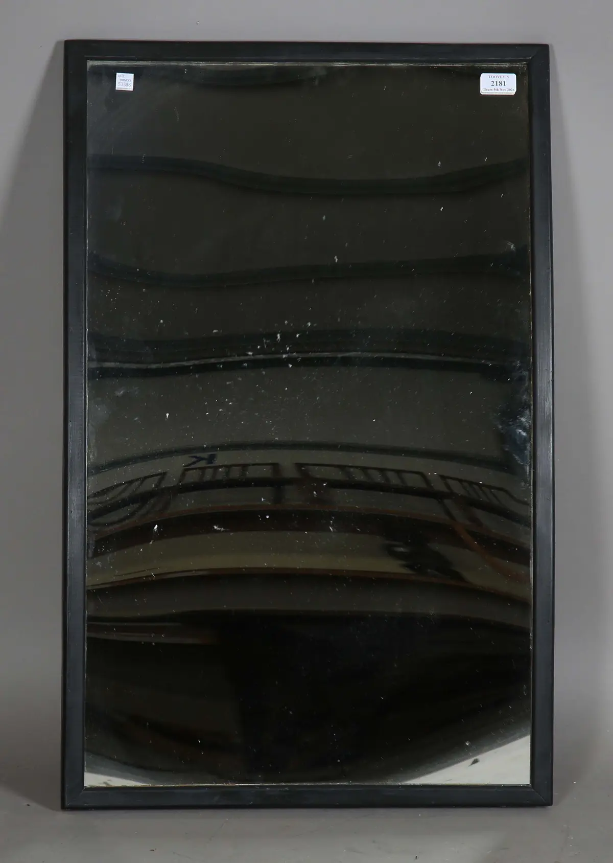 An early 20th century black painted wooden framed distortion circus