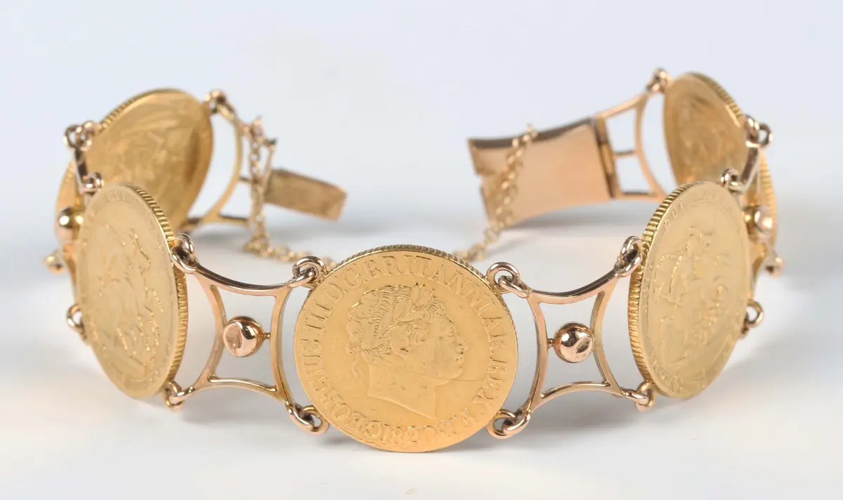 A gold bracelet, mounted with four George III sovereigns 1820 and