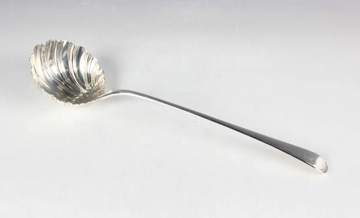 A George III silver Old English pattern soup ladle with scalloped