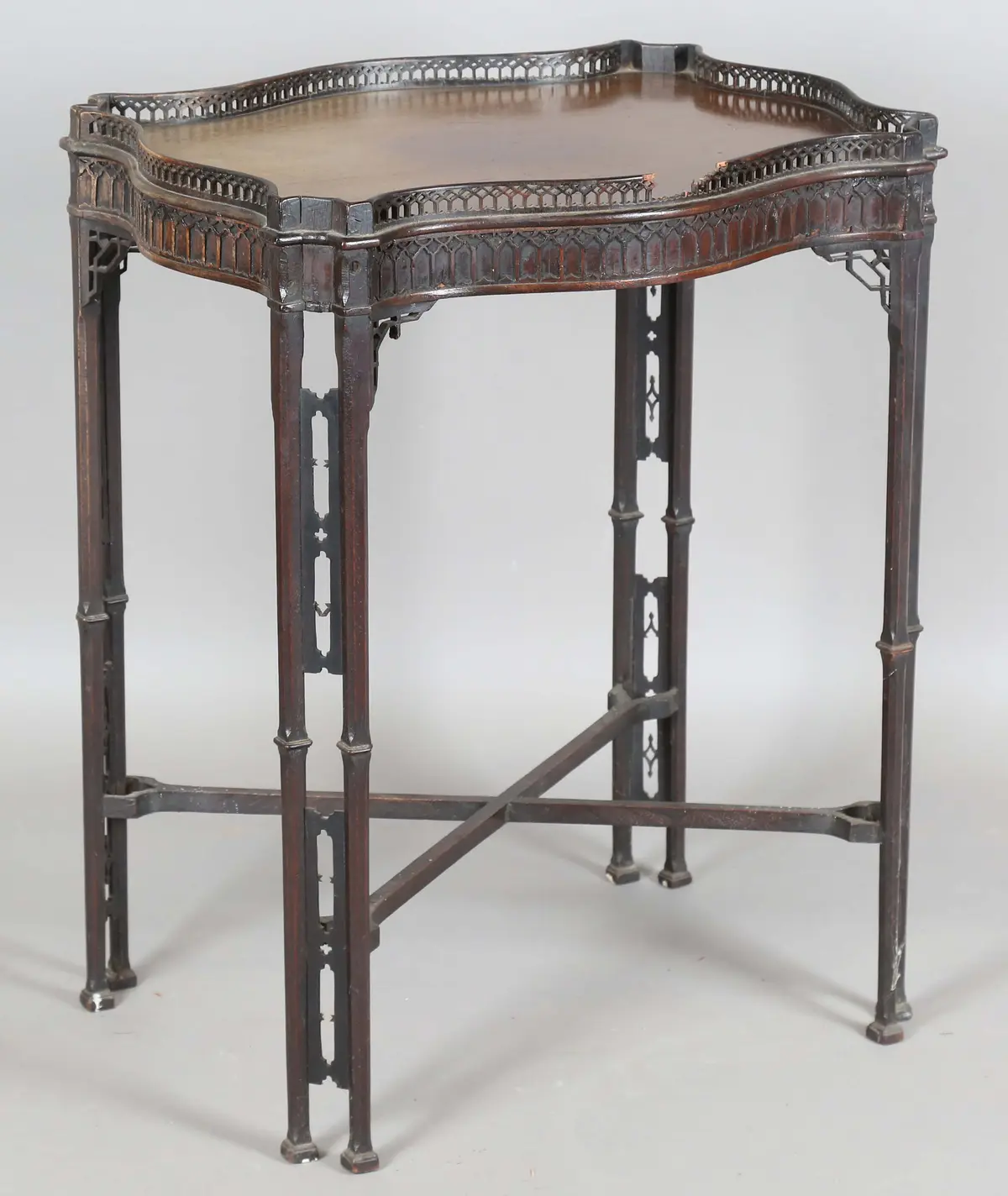 A George III Chippendale period mahogany silver table, the serpentine