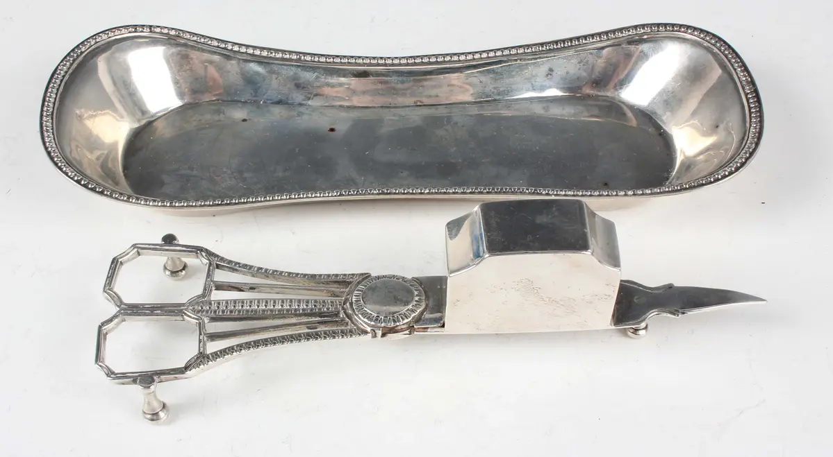 A pair of George III silver candle snuffers with gadrooned handles