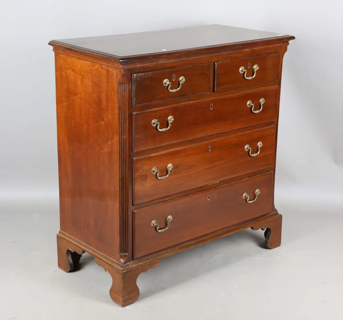 A 20th century George III style mahogany chest of oak-lined drawers