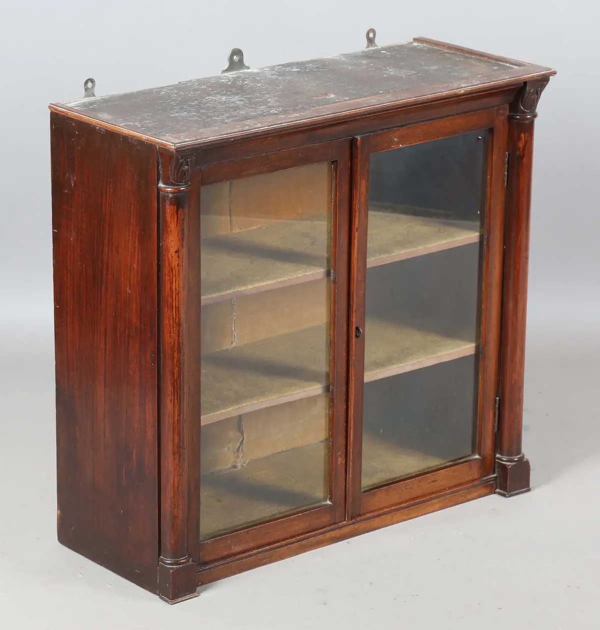 A 19th century mahogany hanging two-door cabinet, fitted with two