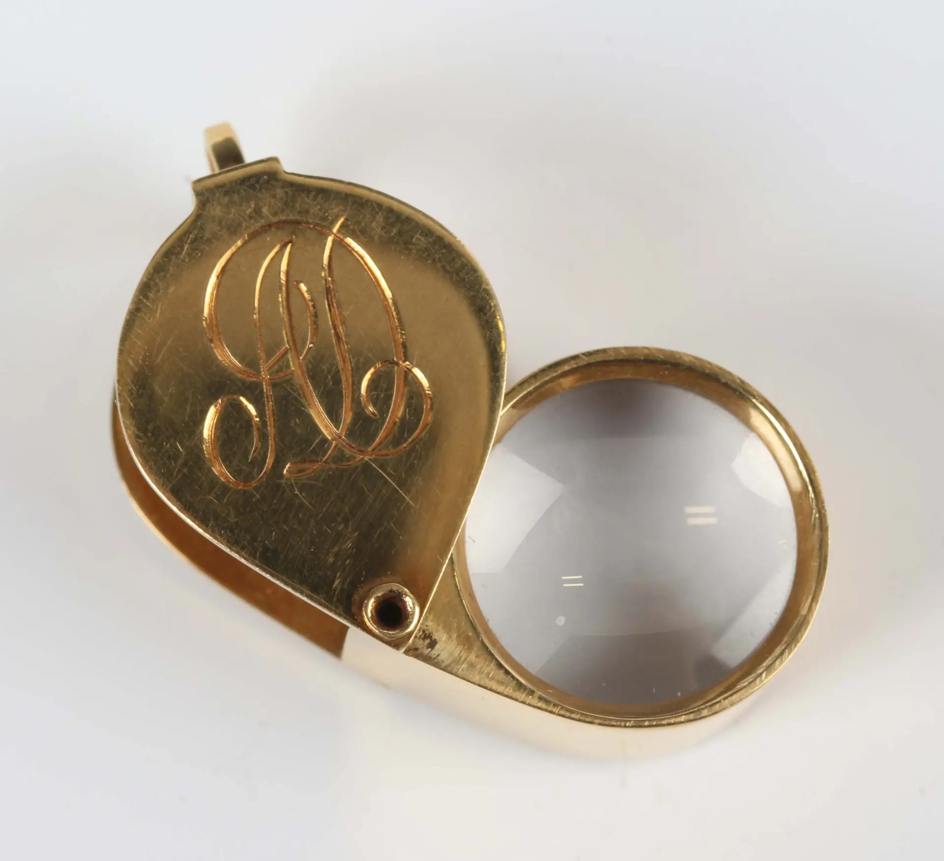 An 18ct gold mounted jewellers folding loupe, initial engraved 'AD'