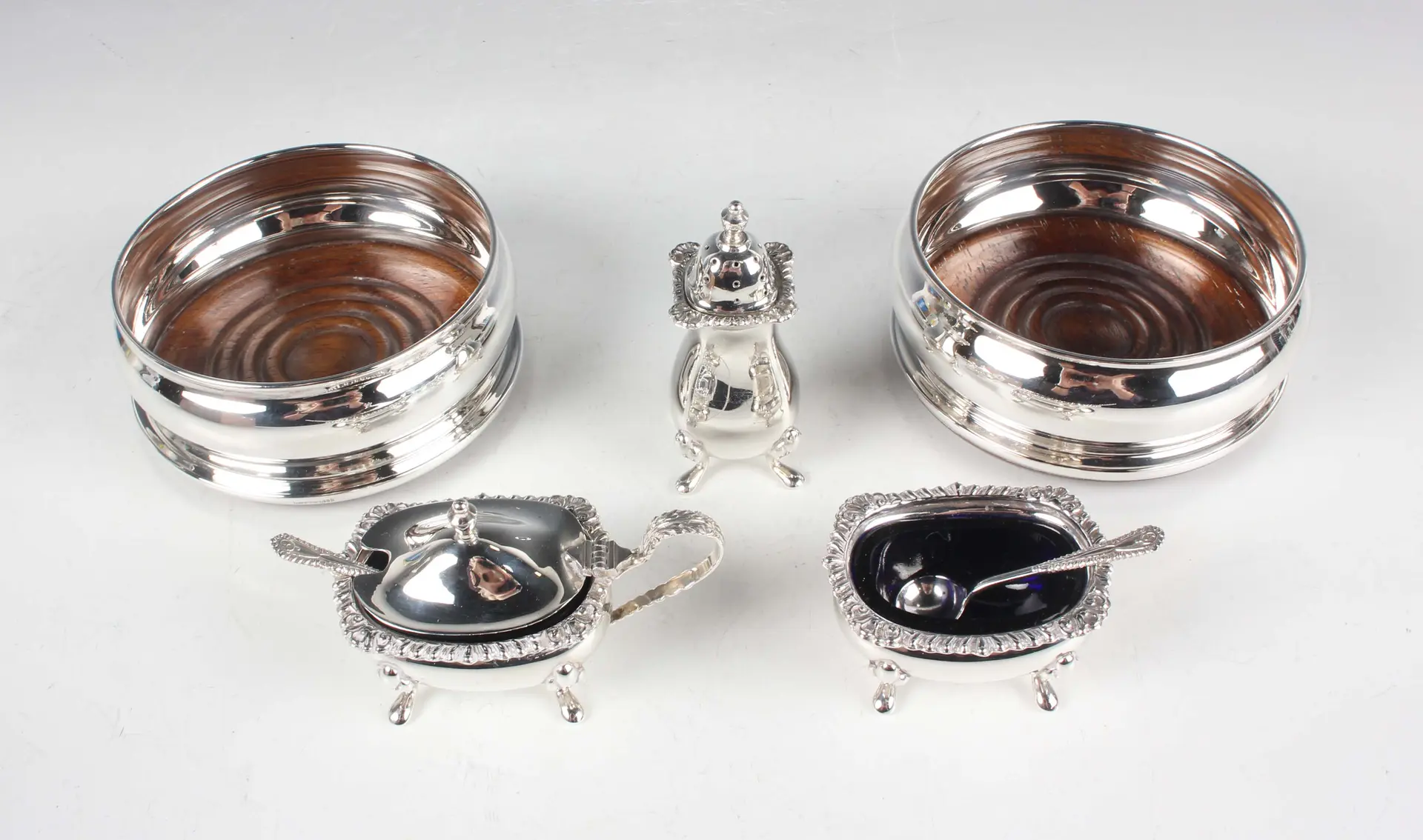 An Elizabeth II silver three-piece condiment set of cushion form with