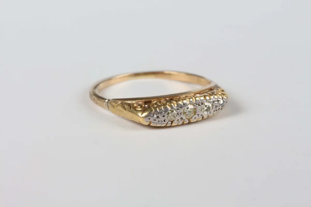 A gold and diamond five stone ring, mounted with a row of variously