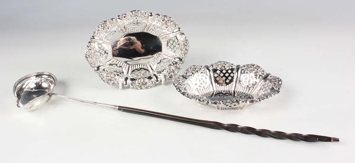 A pair of Edwardian silver oval bonbon dishes, the lobed sides pierced