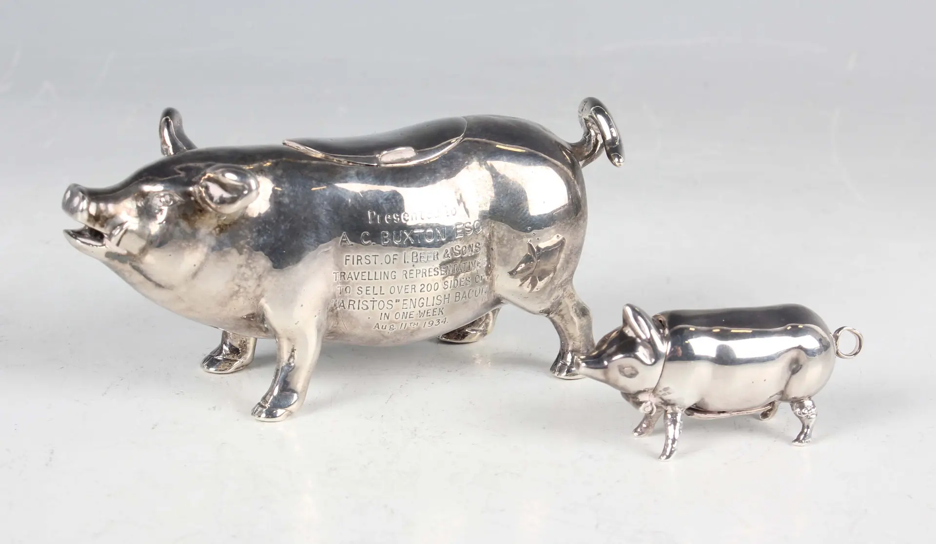 An early 20th century silver pig creamer, modelled standing with curled