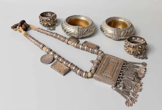 An Omani Silver Amulet, Two Bangles and Two Others