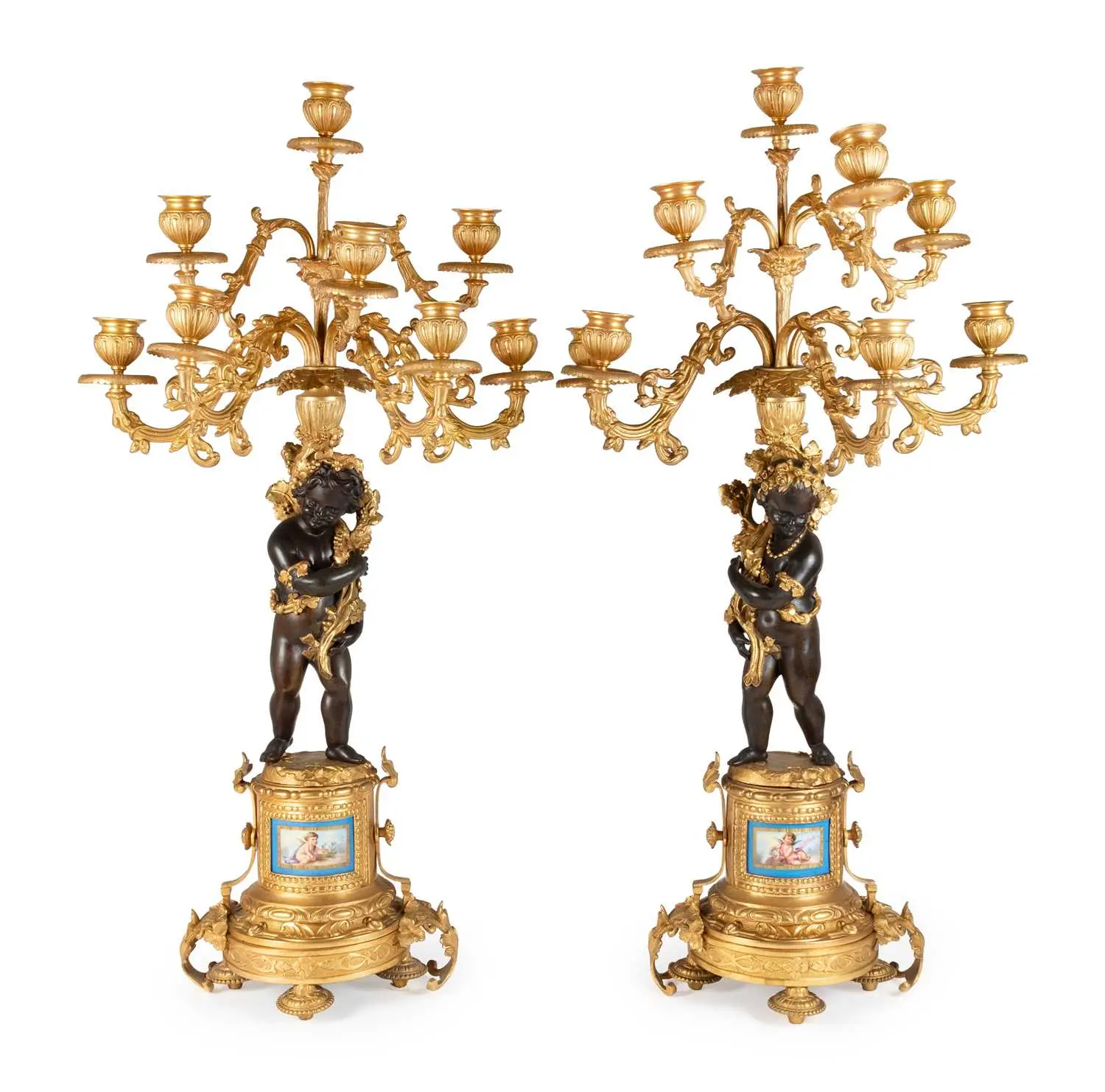 A Pair of Gilt and Patinated Bronze Eight-Light Figural Candelabra