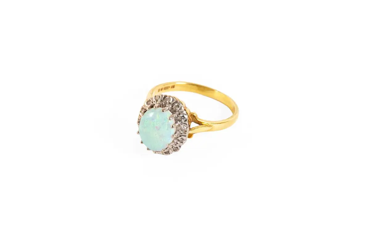 An 18 Carat Gold Opal and Diamond Cluster Ring