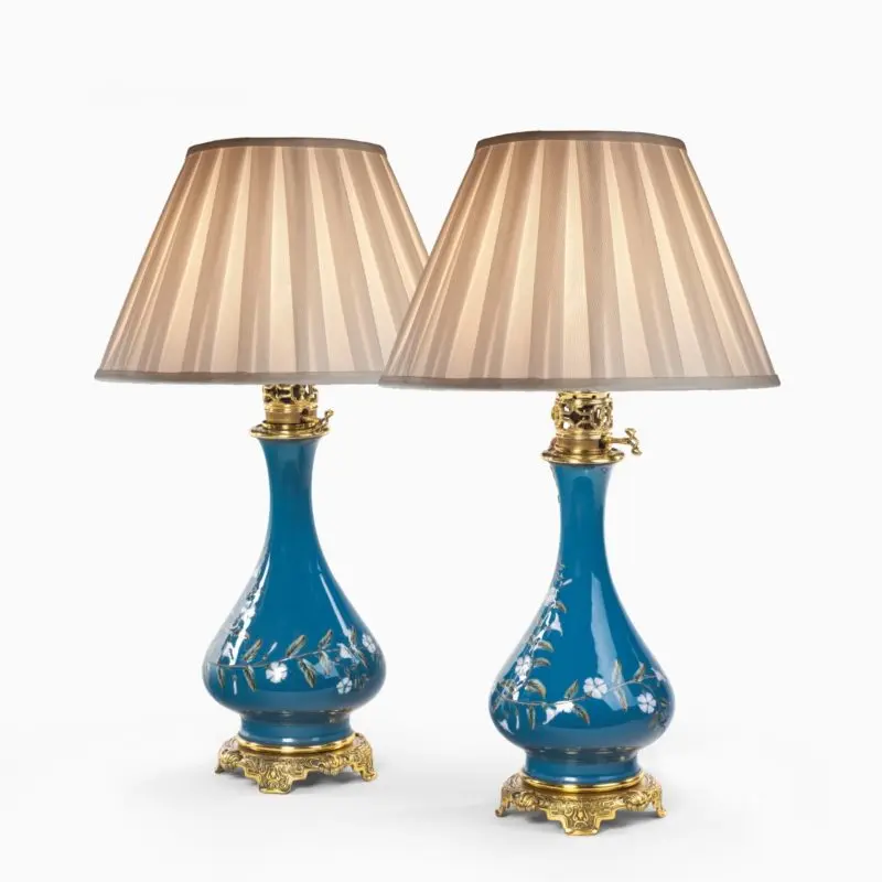 A pair of French pate-sur-pate ceramic oil lamps