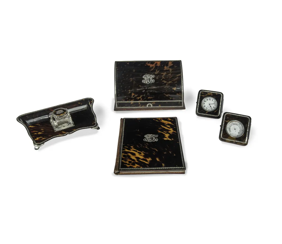 An extensive Edwardian 5-piece silver mounted tortoiseshell desk set