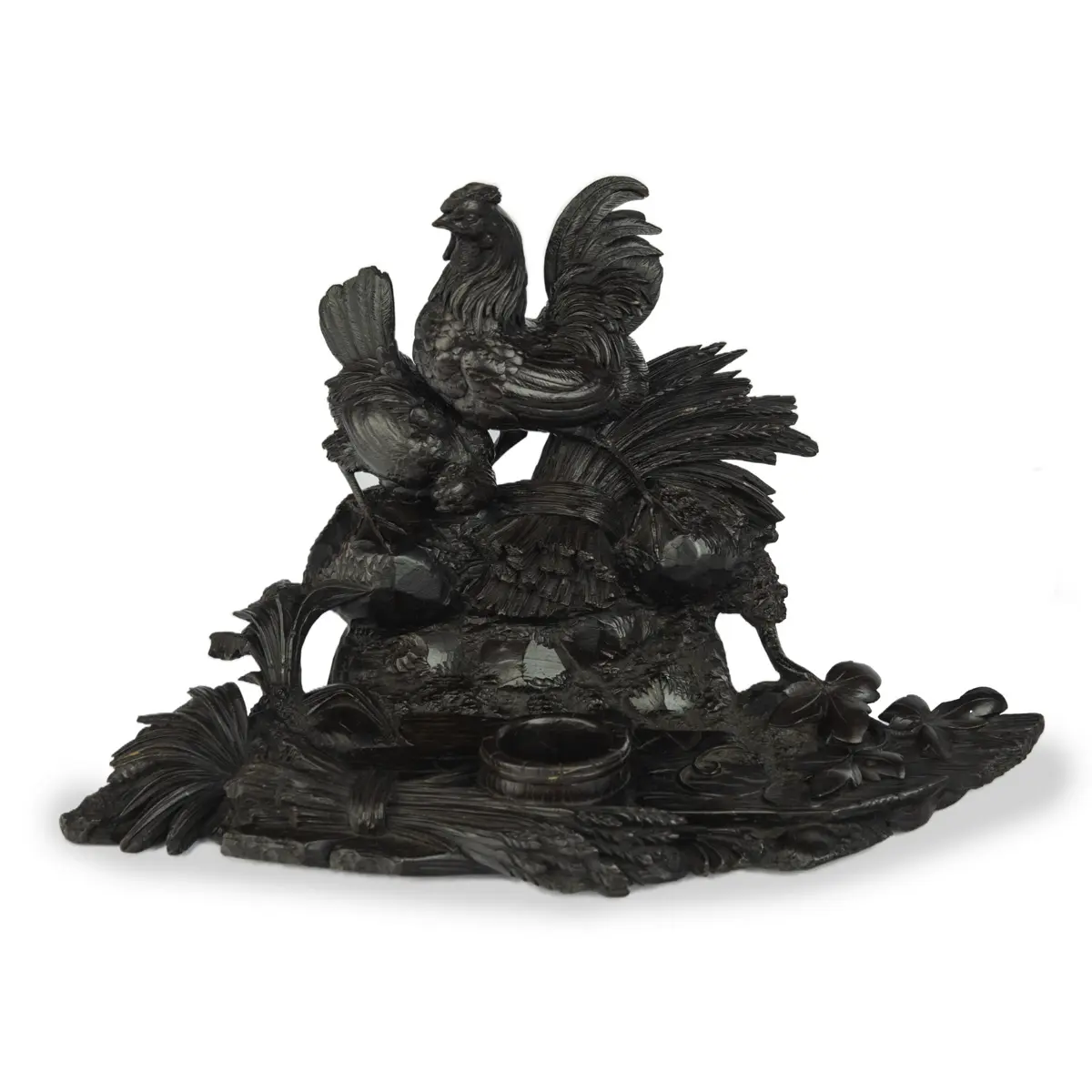 A Black Forest carved wood inkwell with wheat sheafs and poultry