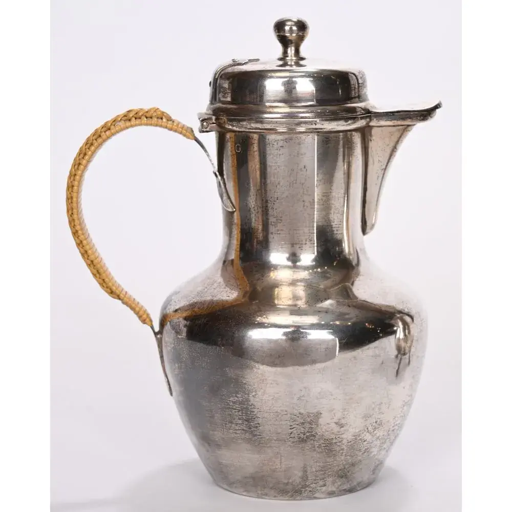Plain silver pitcher. Duck-shaped spout. Wicker handle. PB. 292 grams.