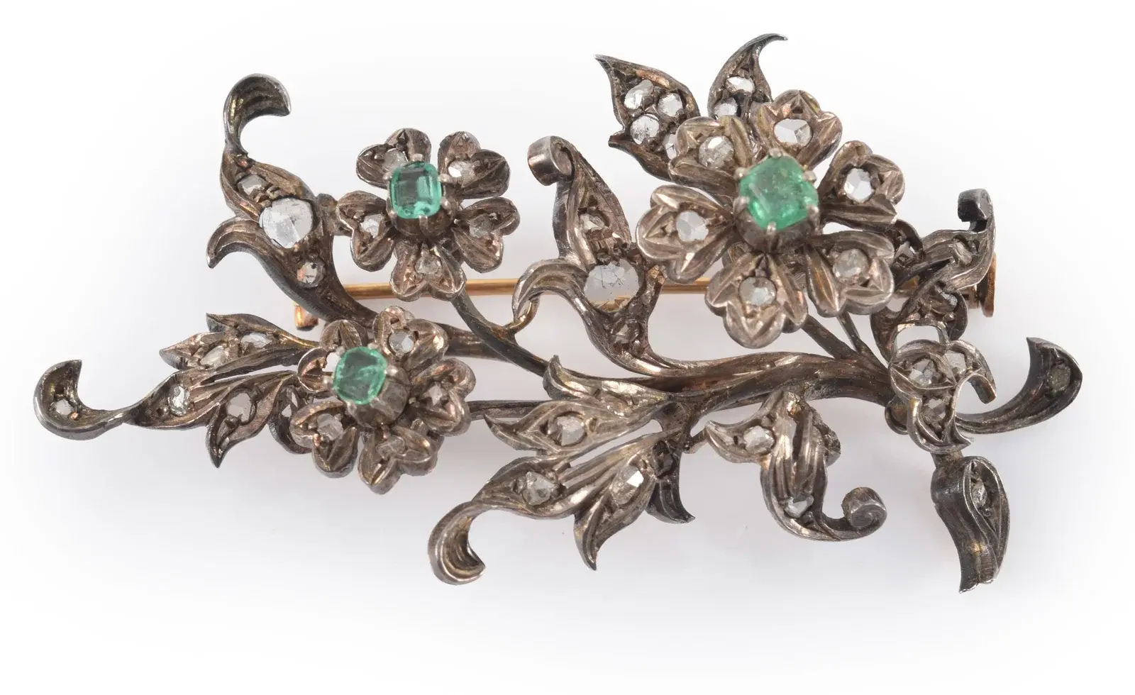 Antique 18K gold emerald and diamond floral brooch. Silvered top with
