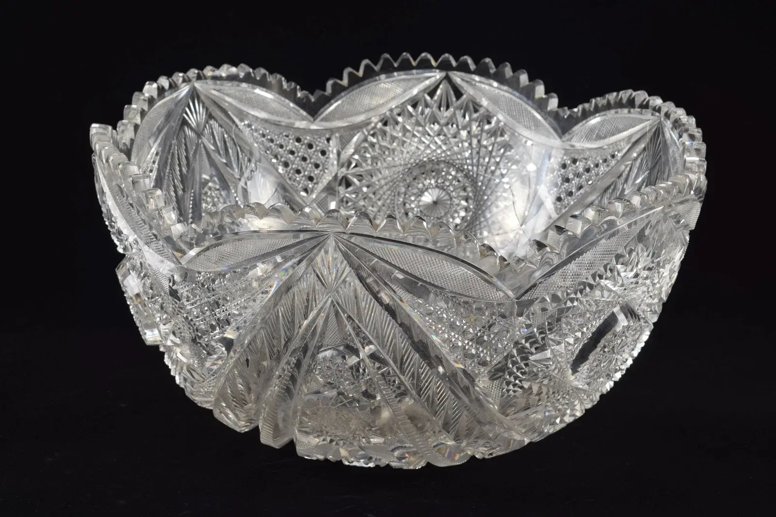Large cut glass punch bowl with bold pinwheel decorations.. Diameter 14 in.