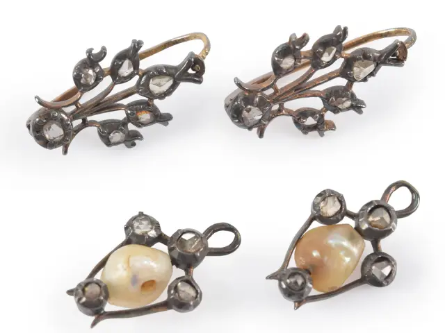 2 pairs of antique diamond earrings. 1) Floral design earrings with