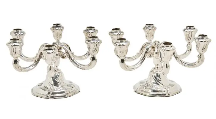 A pair of silver candelabra, each with six curved light arms. 835S.