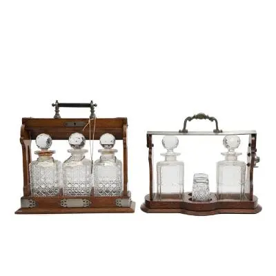 Two oak tantalus cabinets containing crystal glass decanters. Early