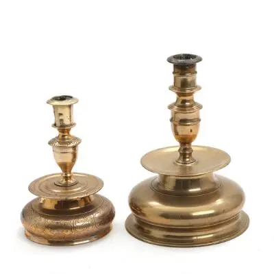 Two Baroque brass candlestick, the smaller one engraved with floral