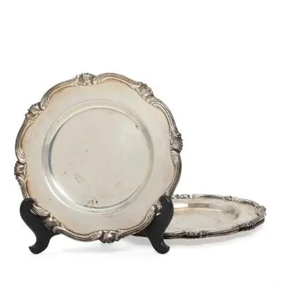 A set of three Peruvian bottle coasters of sterling silver, rim decorated