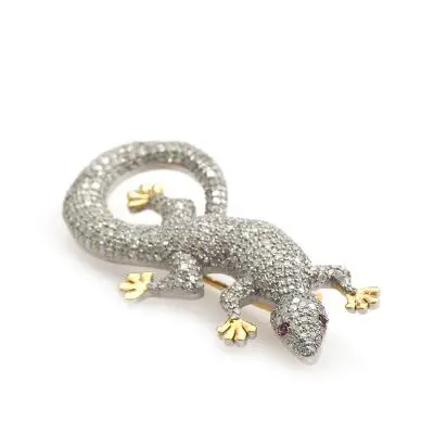 A lizard diamond and ruby brooch, decorated with single-cut diamonds