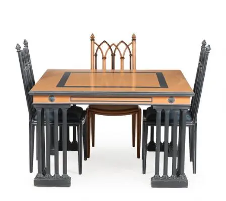 A 20th century partially painted Gothic style dining table and three