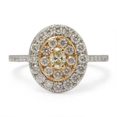 A diamond ring set with a yellow diamond encircled by numerous diamonds