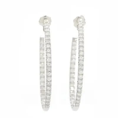 A pair of diamond ear hoops set with numerous brilliant-cut diamonds