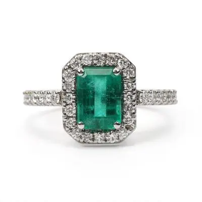 An emerald and diamond ring set with an emerald and diamonds, mounted