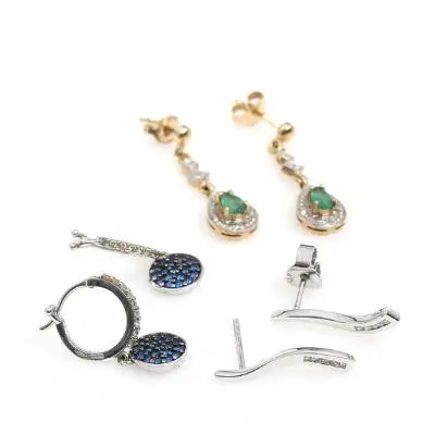 Three pairs of earrings respectivly of 9k and 18k gold and white gold.