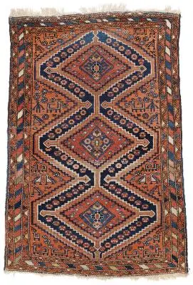 A Hamadan rug, Persia. Linked step medallion on a red field with animal
