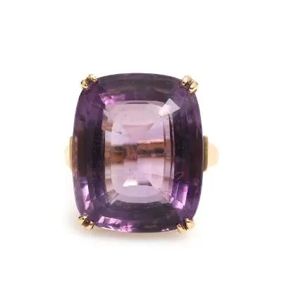 An amethyst ring set with faceted amethyst, mounted in 14k gold. Size