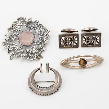 Four silver jewellery pieces: three brooches and a pair of cufflinks.
